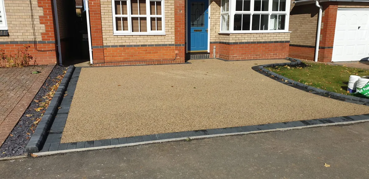 Golden resin driveway at the front of a house