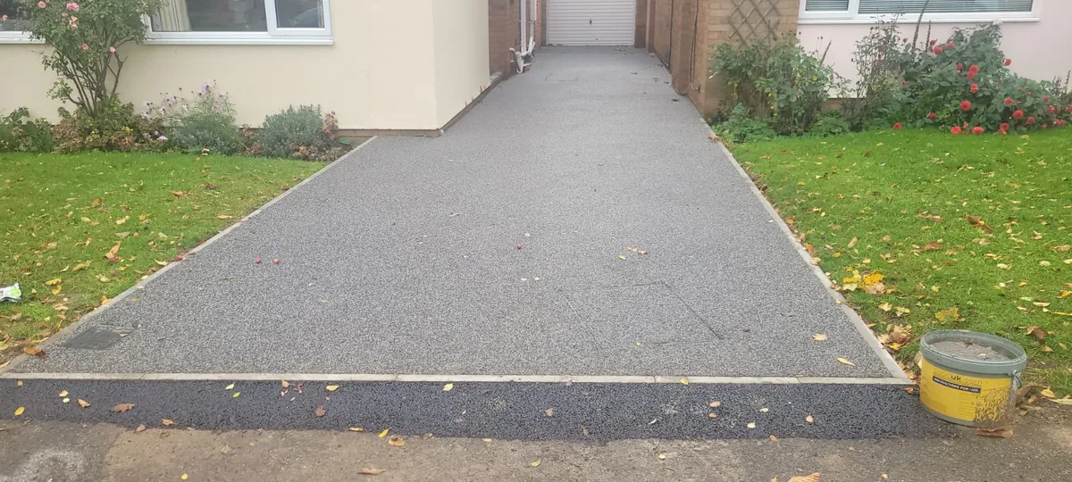 Grey resin path beside a lawn